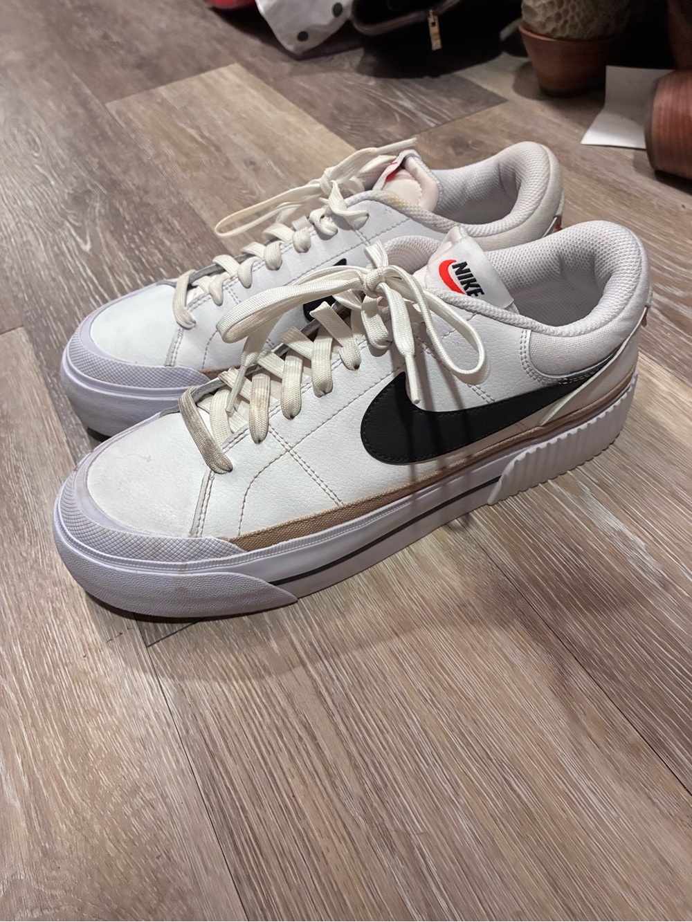Nike women’s White Leather Low-Top Sneakers with Black Swoosh